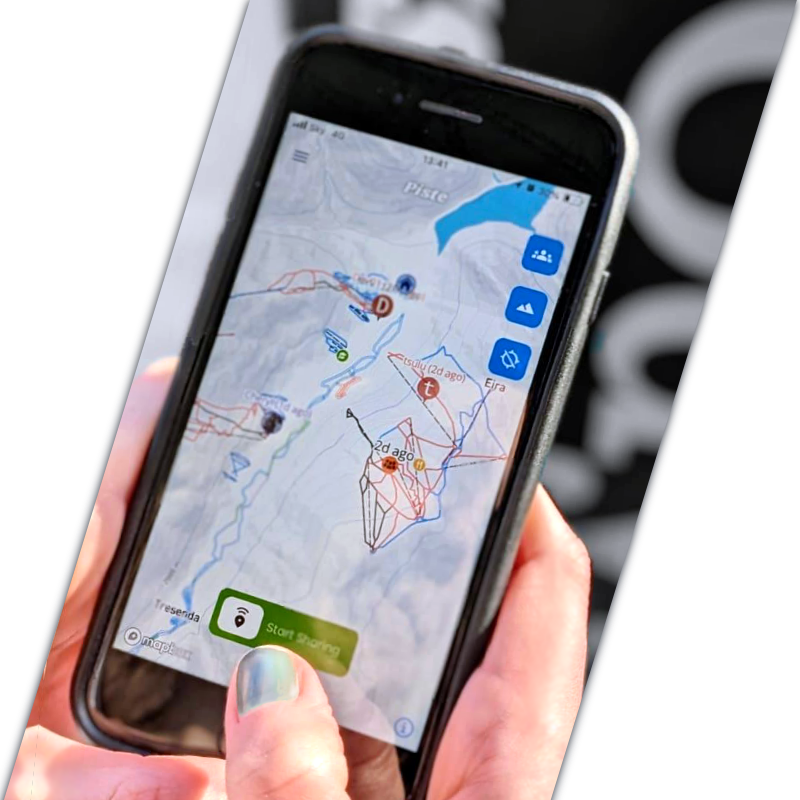 User holding an Iphone with the Piste Map App Open